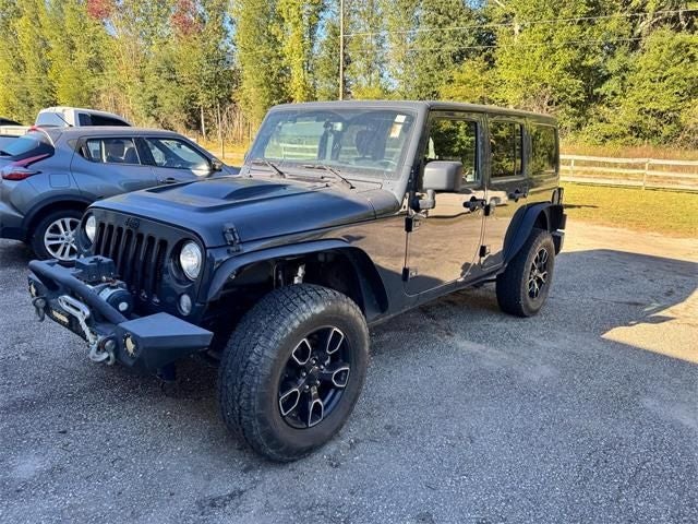 2017 Jeep Wrangler Unlimited Sahara in Rhino Clearcoat — front three-quarter view